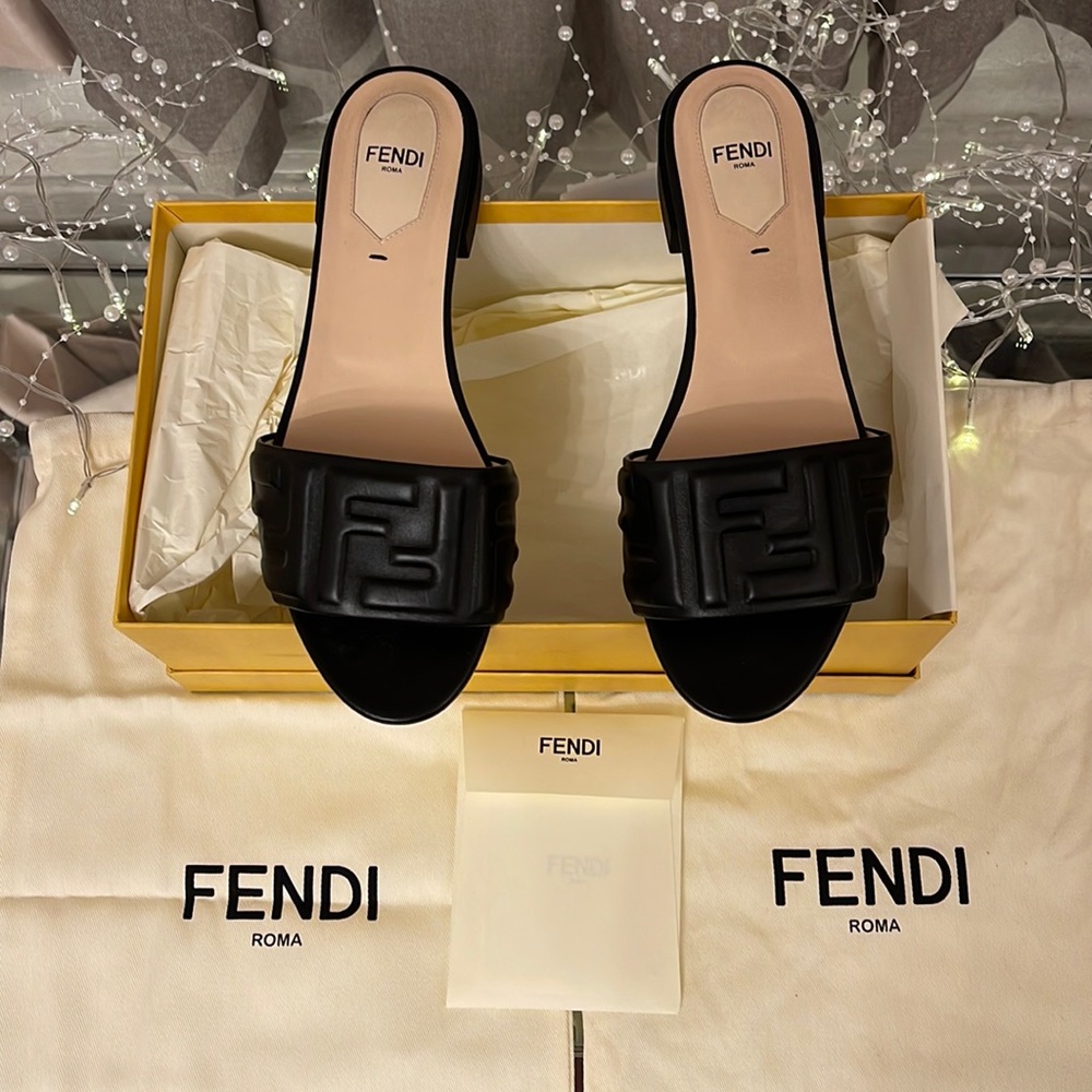 Fendi Rich leather mules embossed with Fendi's signature double-F motif.